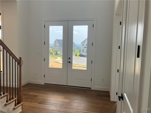 entryway featuring dark hardwood / wood-style floors and french doors