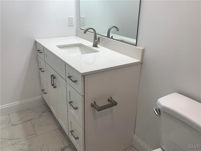 bathroom featuring toilet and vanity