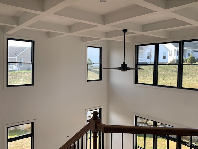 stairs with a healthy amount of sunlight and coffered ceiling