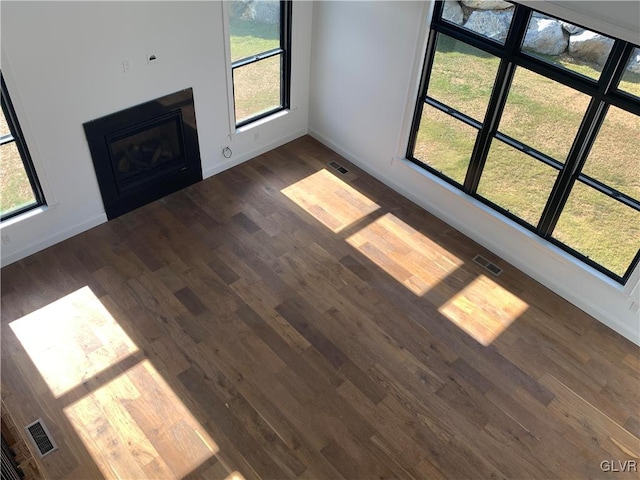 unfurnished living room featuring dark hardwood / wood-style flooring