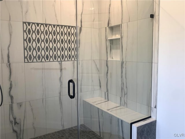 bathroom with a shower with shower door