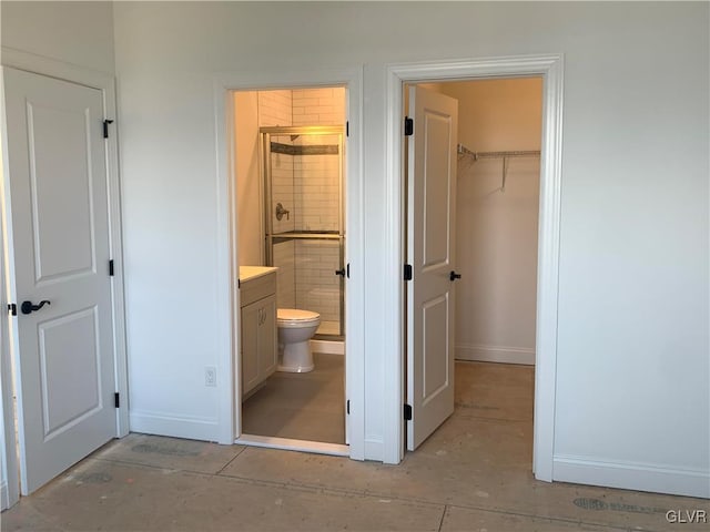 bathroom featuring vanity, toilet, and an enclosed shower