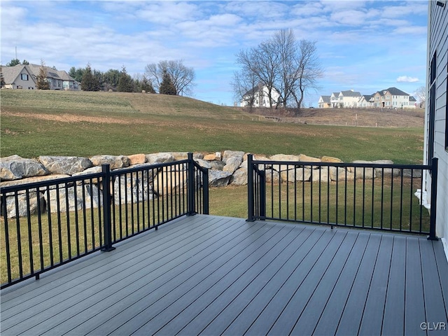 wooden terrace featuring a lawn