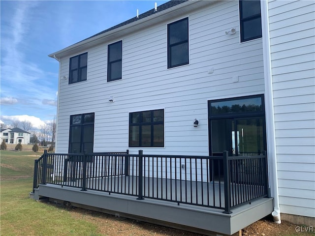 rear view of property featuring a wooden deck