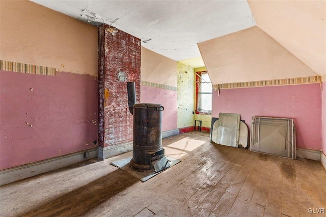 bonus room with wood-type flooring and vaulted ceiling