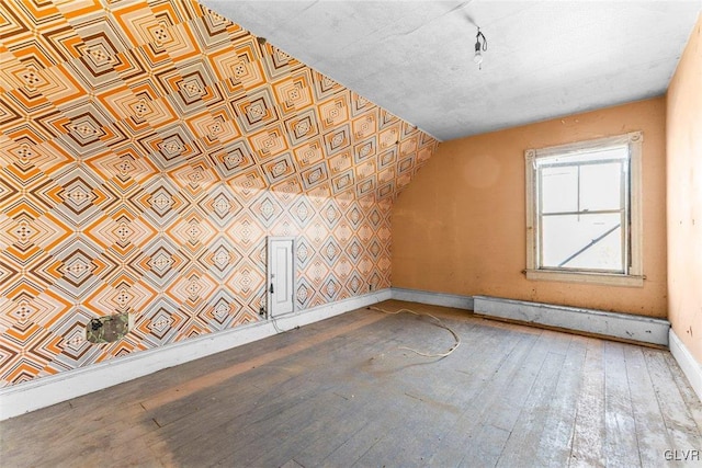824 Wolf Ave, Easton, PA 18042 - additional living space with wood-type flooring, baseboards, and a baseboard heating unit