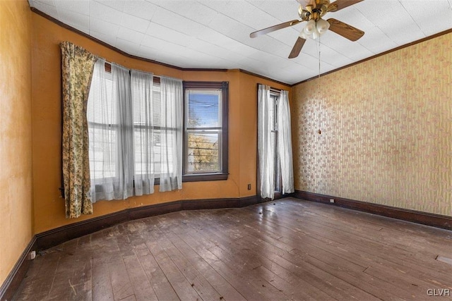 unfurnished room with ceiling fan, a healthy amount of sunlight, dark hardwood / wood-style floors, and ornamental molding