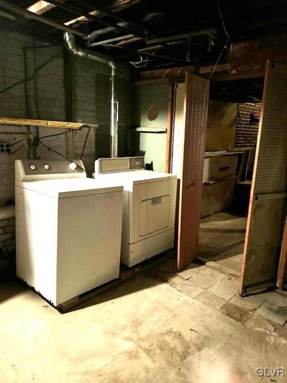 clothes washing area with washer and dryer