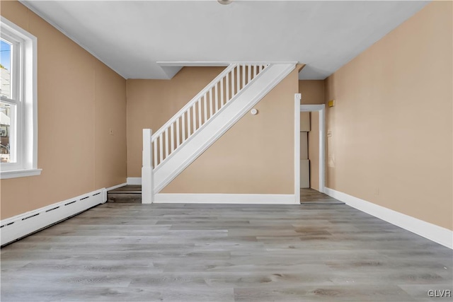 interior space with hardwood / wood-style flooring and a baseboard radiator