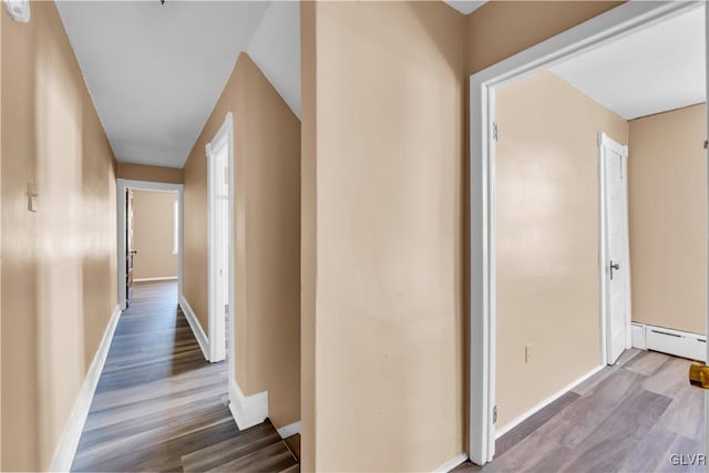 corridor featuring hardwood / wood-style flooring and a baseboard radiator