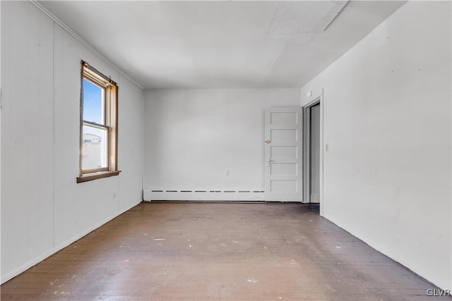 empty room with baseboard heating and hardwood / wood-style flooring