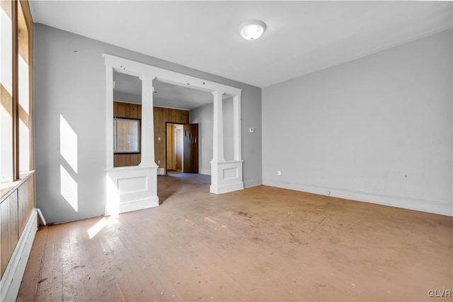 unfurnished room with hardwood / wood-style floors and a baseboard radiator