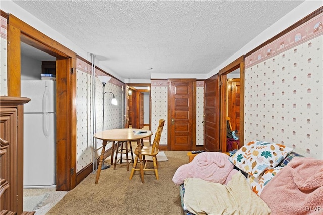 dining space featuring carpet and a textured ceiling