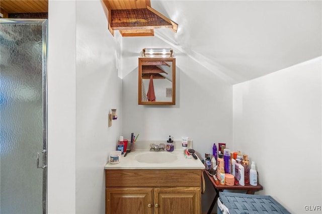 bathroom featuring vanity and a shower with shower door