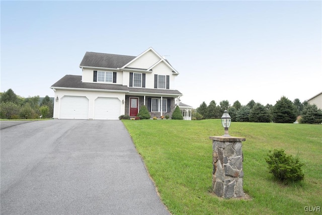 view of front facade with a front lawn and a garage