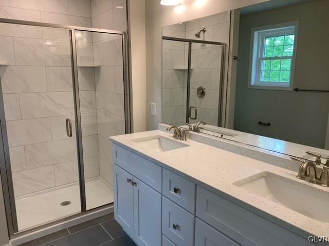 bathroom with tile patterned flooring, vanity, and an enclosed shower