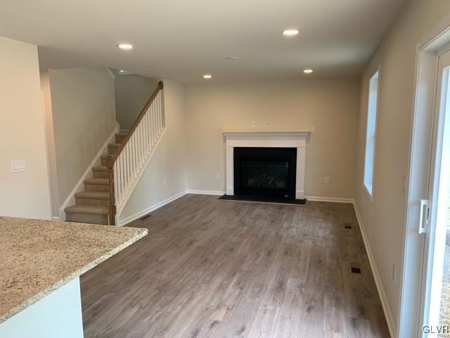 unfurnished living room featuring dark hardwood / wood-style floors