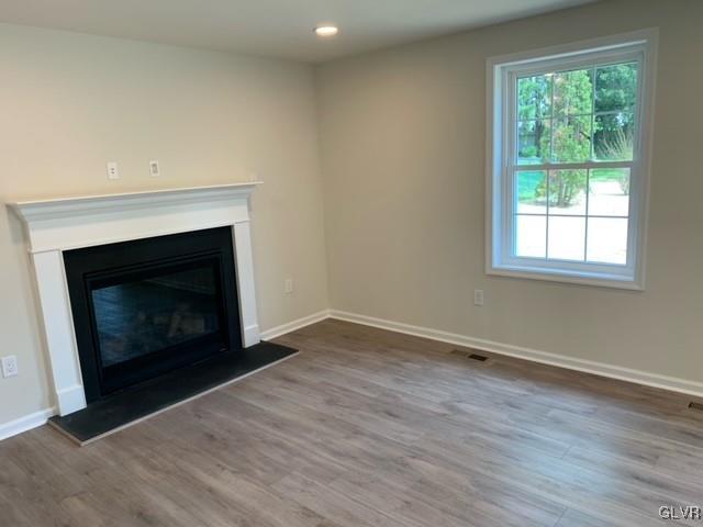 unfurnished living room featuring hardwood / wood-style flooring