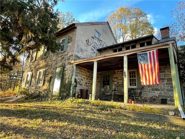 rear view of house featuring a lawn