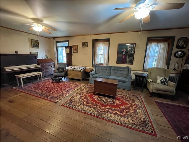 living room featuring ceiling fan, ornamental molding, and hardwood / wood-style flooring