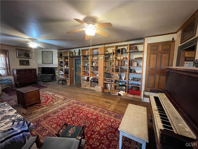 sitting room featuring ceiling fan and hardwood / wood-style floors