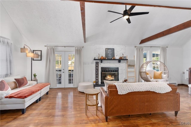 living room with vaulted ceiling with beams, french doors, wood-type flooring, and a textured ceiling