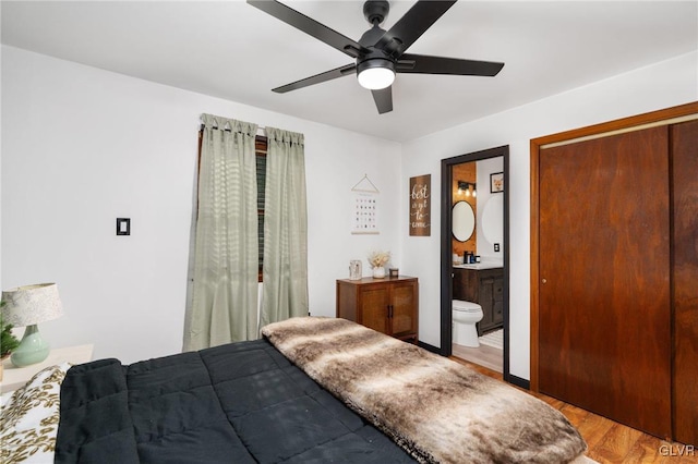 bedroom with ensuite bath, ceiling fan, and light hardwood / wood-style floors