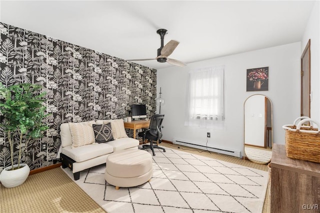 living room with baseboard heating, ceiling fan, and light hardwood / wood-style floors