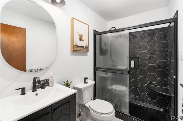 bathroom featuring vanity, toilet, and walk in shower