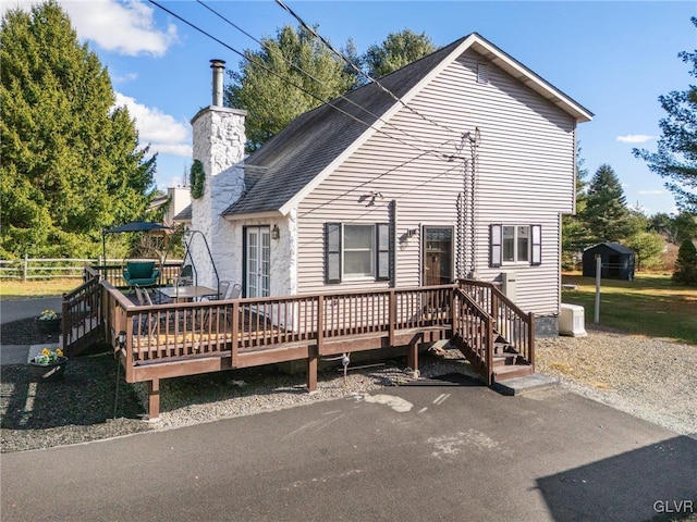 back of house featuring a wooden deck