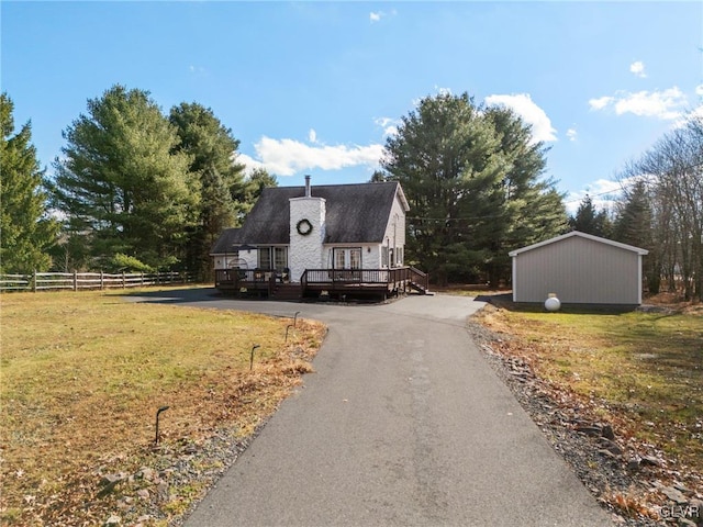 view of front of property featuring a front lawn and a deck