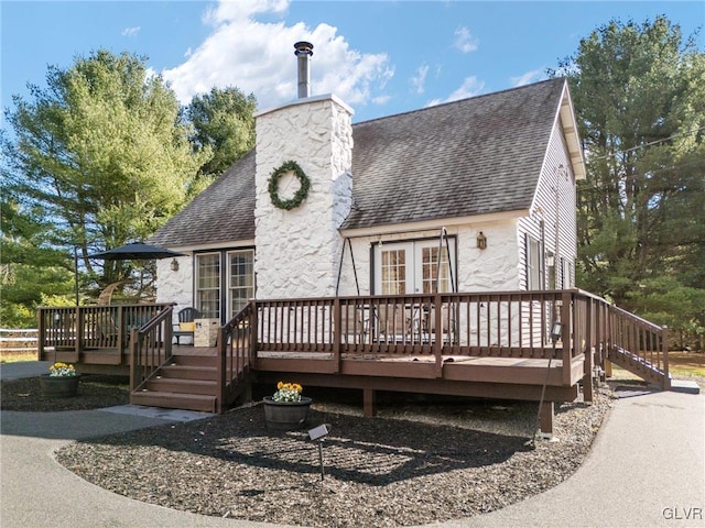 rear view of property featuring a deck