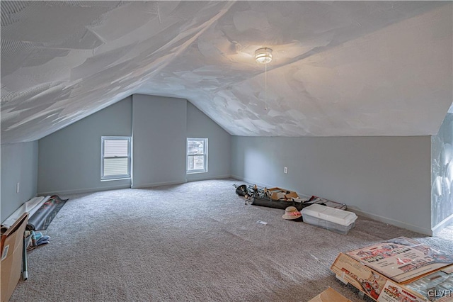 bonus room with carpet flooring and lofted ceiling