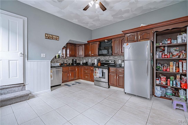 kitchen with backsplash, ceiling fan, light tile patterned floors, and stainless steel appliances