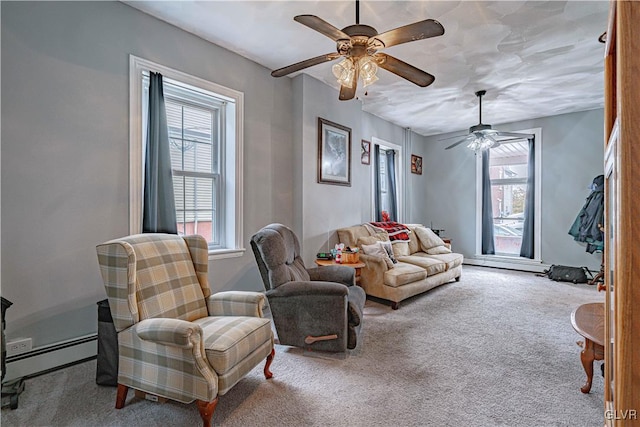 living room featuring ceiling fan, light carpet, and a baseboard heating unit