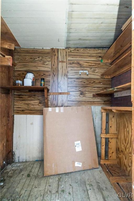 interior space with lofted ceiling, hardwood / wood-style flooring, wooden walls, and wood ceiling