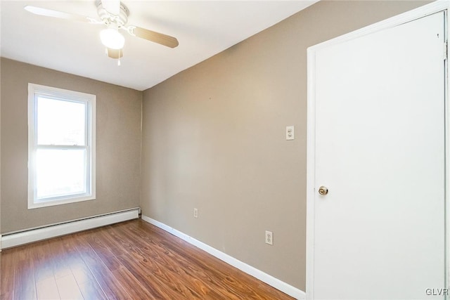 empty room featuring hardwood / wood-style flooring, ceiling fan, and a baseboard radiator