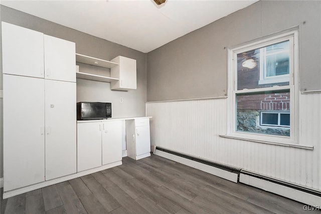 kitchen with white cabinets, dark hardwood / wood-style flooring, and a baseboard radiator