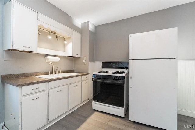 kitchen with sink, white cabinets, white appliances, and light wood-type flooring