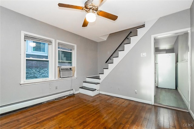 interior space featuring hardwood / wood-style flooring, ceiling fan, cooling unit, and baseboard heating