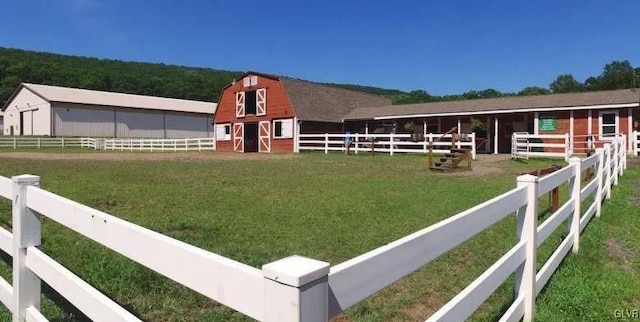 view of horse barn featuring a rural view