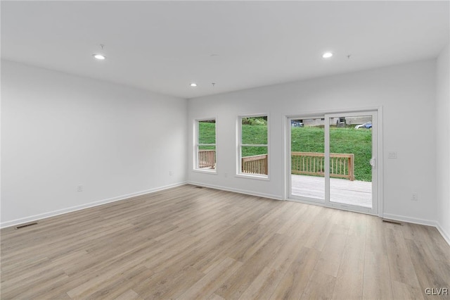 spare room with light hardwood / wood-style flooring