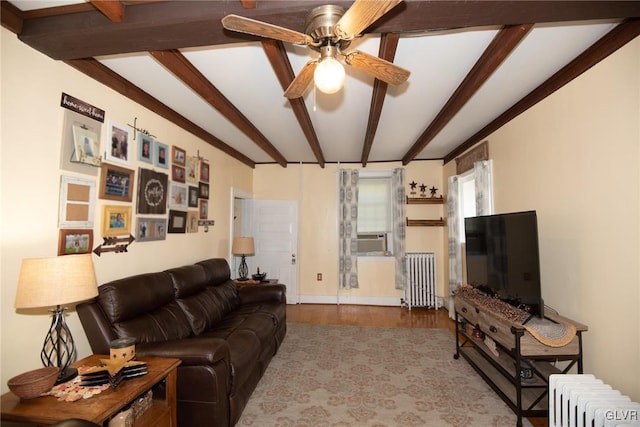 living room with beam ceiling, ceiling fan, radiator heating unit, and light hardwood / wood-style floors