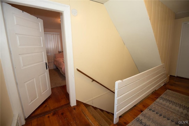 stairs featuring hardwood / wood-style floors