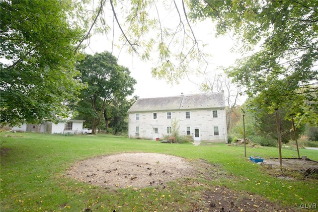 back of house with a lawn