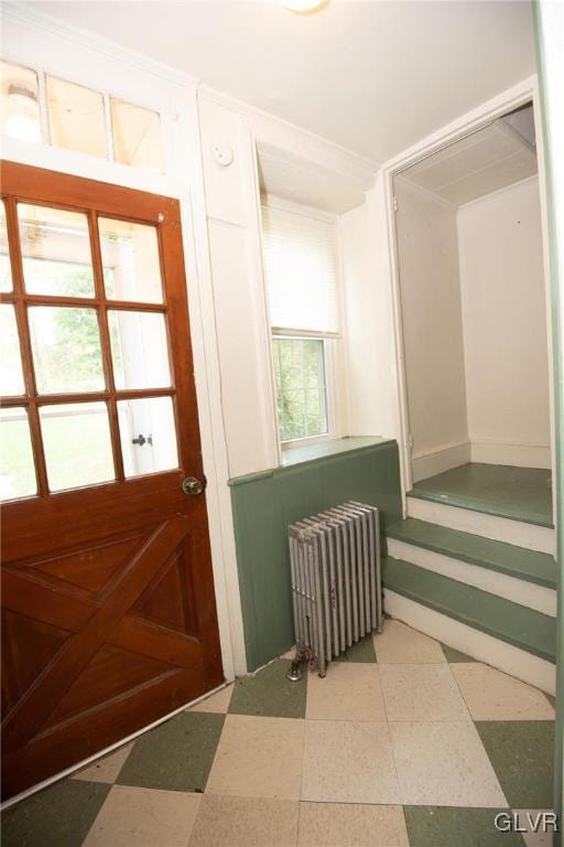 doorway to outside with radiator heating unit