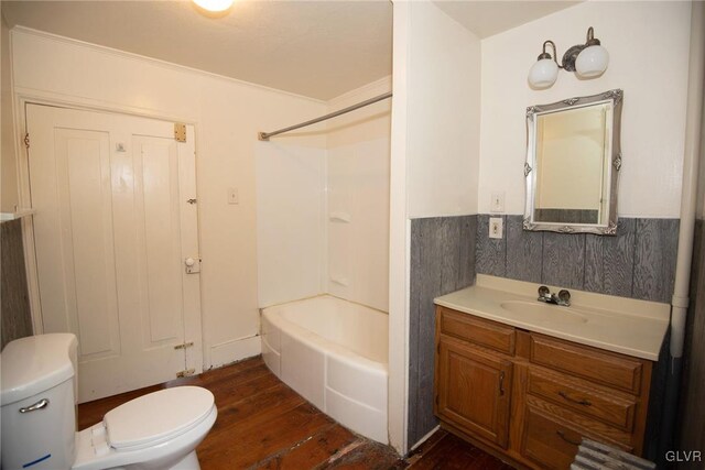 full bathroom featuring hardwood / wood-style floors, toilet, vanity, bathtub / shower combination, and ornamental molding