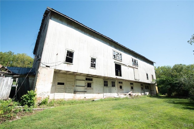 rear view of property featuring a yard