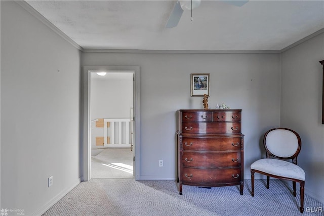 sitting room featuring ceiling fan, crown molding, and light carpet