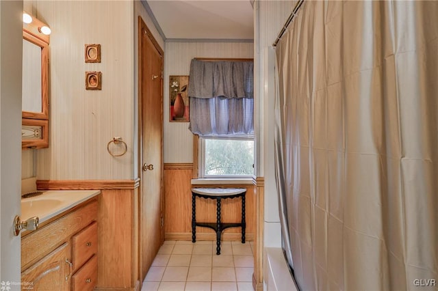 bathroom with tile patterned floors, vanity, a shower with curtain, and wooden walls